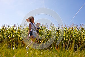 Mother with baby on the corn field