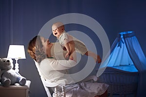 Mother and baby in dark bedroom