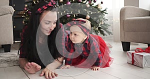 Mother with baby daughter celebrating Christmas at home
