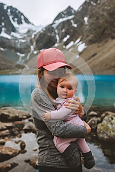Mother and baby daughter family traveling together in mountains