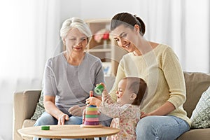 Mother, baby daughter and granny playing at home