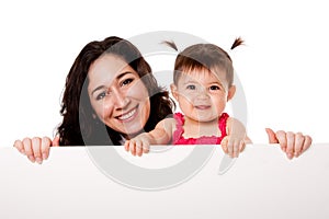 Mother and baby daughter holding white board