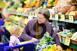 Mother and baby daughter in supermarket