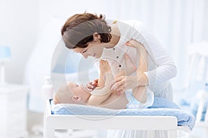 Mother and baby in diaper on changing table