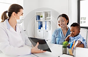 Mother, baby and doctor in mask with tablet pc