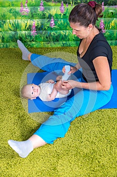 Mother with baby doing gymnastics