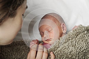 Mother and baby face close-up. Motherhood, newborn care, children's sleep.
