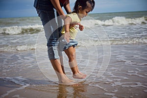 Mother and baby feet on sand summer beach. Family insurance support concept