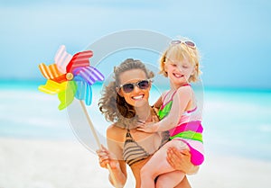 Mother and baby girl with colorful windmill toy