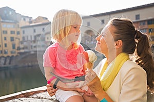 Mother and baby girl eating ice cream in florence