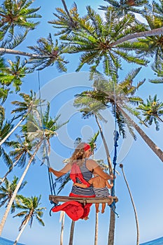 Mother with baby girl fly high in sky on swing