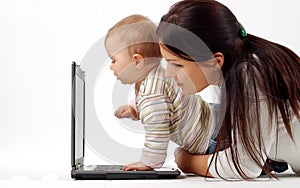 Mother and baby girl with laptop