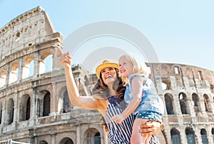 Mother and baby girl sightseeing near colosseum