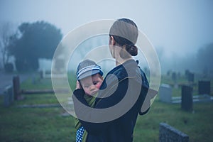 Mother and baby in graveyard