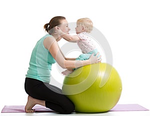 Mother with baby having fun gymnastic