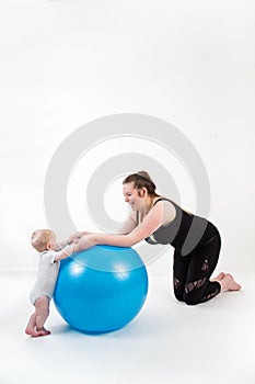 mother with baby having fun with gymnastic ball