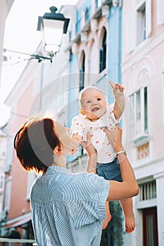 Mother with baby in historical old town of Piran, Slovenia