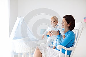 Mother and baby at home. Mom and child in bedroom