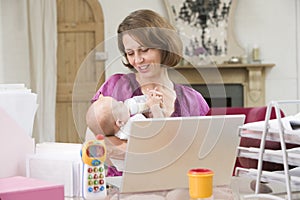 Mother and baby in home office