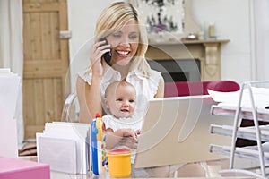 Mother and baby in home office and telephone