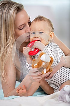 mother and baby kissing laughing and hugging