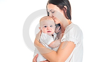 Mother and baby kissing and smiling. Happy family. White background