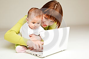 Mother and baby at laptop