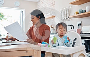 Mother, baby and laptop in kitchen, freelance and paying bills while bonding with down syndrome child. Disability, kids