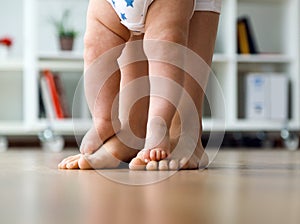 Mother and baby legs. First steps.