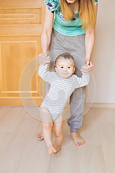 Mother and baby legs. First steps.