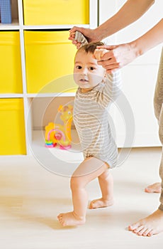 Mother and baby legs. First steps.