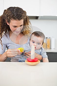 Mother with baby looking at toys