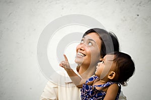 Mother and baby looking up and pointing