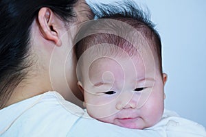 Mother and baby, Lovely asian girl resting on her mother's shoul