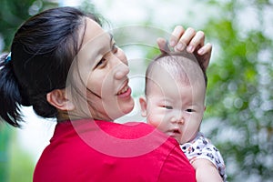 Mother and baby, Lovely asian girl resting on her mother's shoul