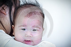 Mother and baby, Lovely asian girl resting on her mother`s shoul