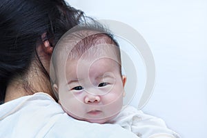 Mother and baby, Lovely asian girl resting on her mother's shoul