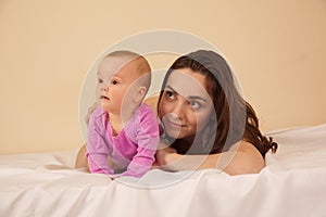 Mother with baby lying on bed