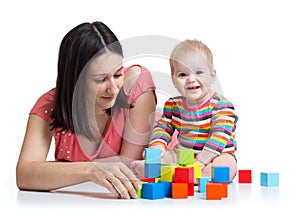 Mother and baby play with building blocks toy isolated on white