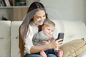 Mother and baby playing with a smart phone