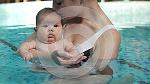 Mother with baby in the pool