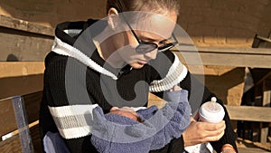 Mother and baby preparing for feeding formula sitting on bench