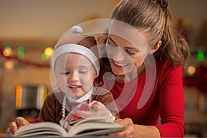 Mother and baby reading christmas book