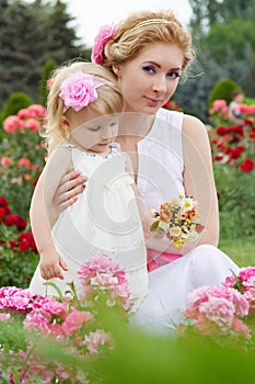 Mother and baby in rose garden