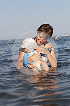 Mother with baby in sea