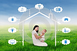 Mother and baby sit under smart house design