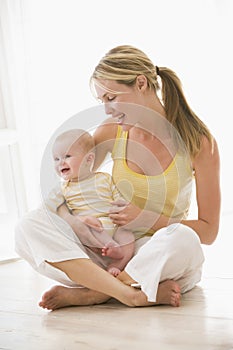 Mother and baby sitting indoors