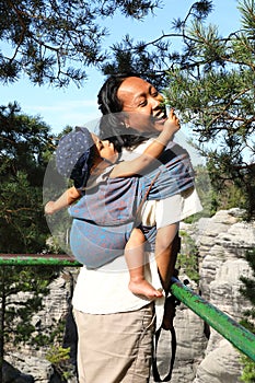 Mother with baby in sling in Prachov Rocks