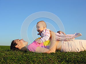 Mother with baby on sunset lie