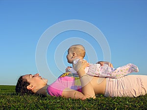 Mother with baby on sunset lie